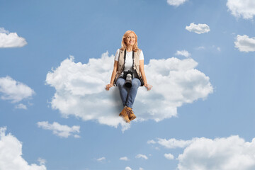 Female photo reporter sitting on a cloud