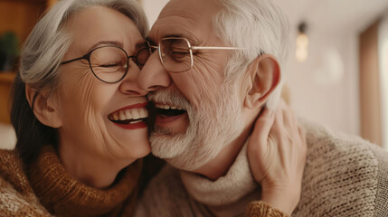 An older man and woman are joyfully smiling while hugging each other in a heartwarming moment.