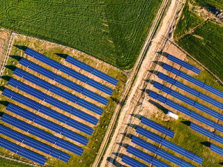 Sunset Glow of Green Energy: 4K UHD image of Solar Panel Power Plant in Beautiful Green Fields -...