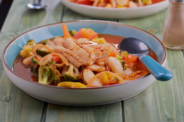 White fish and butter bean stew,with vegetables and a spicy tomato sauce.