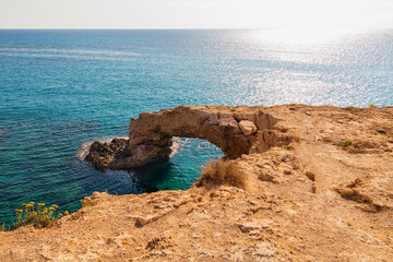 View of the stone arch entering the sea. A popular tourist destination. Lovers' Bridge, Ayia Napa, Cyprus