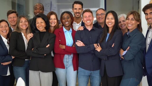 Group of multiracial business people celebrating success inside modern office - Multi generational colleague and entrepreneurs concept 