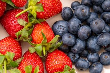 Closeup top view of strawberries and blueberries