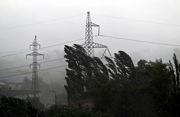 Stormy landscape with high voltage transmission line