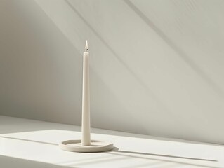 A candle burning brightly on a table in a room