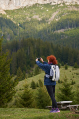 Woman hiker shooting landscapes with her phone - 808263978