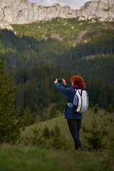 Woman hiker shooting landscapes with her phone - 808263984