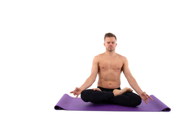 Fitness and meditation. Healthy lifestyle. Young attractive man doing yoga on a white background.