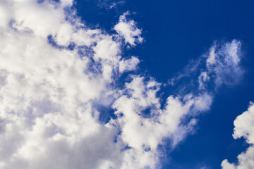 saturated blue sky with partial clound coverage for backgrounds and textures