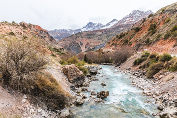 Views from the trekking trail near Lake Iskanderkul to the waterfall in early spring in the Fan Mountains in Tajikistan