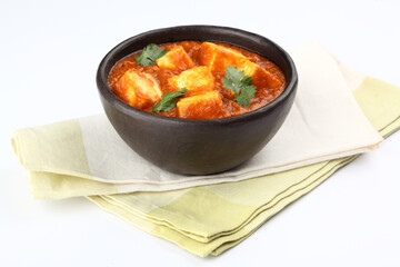 Paneer curry recipe made using cottage cheese, served in a bowl. selective focus Delhi, Rajasthan India.  Indian veg curry also called Paneer butter masala