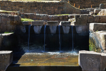 fountain built in stone at the archaeological site of Típon where water comes out through four different spaces