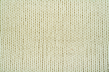 Sweater or scarf fabric texture large knitting. Knitted jersey background with a relief pattern. Wool hand- machine, handmade.
