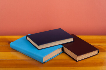 Open book, hardback colorful books on wooden table. Back to school. Copy space for text. Education...