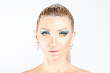 Fashion model woman with a bright make-up posing in studio