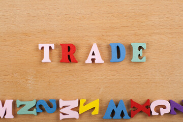 TRADEword on wooden background composed from colorful abc alphabet block wooden letters, copy space...