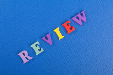 REVENUE word on blue background composed from colorful abc alphabet block wooden letters, copy...
