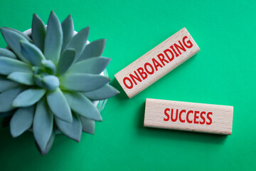 Onboarding Success symbol. Concept word Onboarding Success on wooden blocks. Beautiful green...