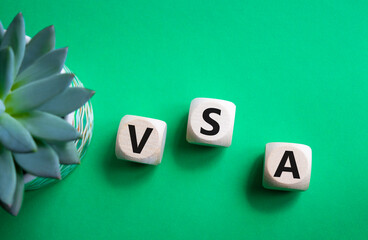 VSA - Volume Spread Analysis symbol. Wooden cubes with word VSA. Beautiful green background with...