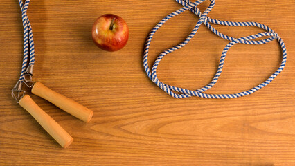 photography of apple next to skipping rope on color background, sports background, healthy living,...