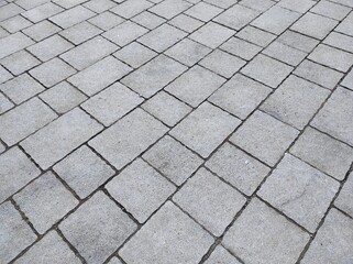 Cobblestone texture. Gray paving stones outside close-up. Design blank
