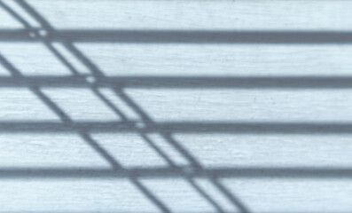 Abstract background of blinds shadow pattern on white painted wood surface. Line pattern and line background.