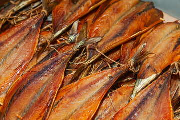 Close-up of a batch of cut, finished smoked fish.