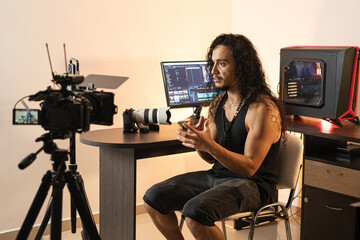 Online Content Creator Studio. A long-haired content creator immersed in his studio, recording...