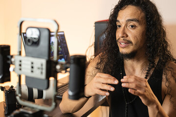 Digital Content Development. A long-haired content creator immersed in his studio, recording videos...