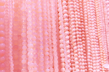 Hanging strings with pink and peach beads abstract background