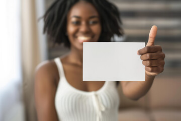 young black woman holding up a white empty sign and giving her thumbs up