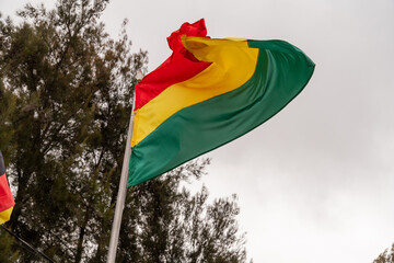Bolivian flag textile cloth fabric waving on the wind
