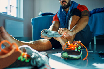 Man taking off dirty shoes at home after workout