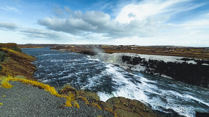 Panoramic summer view of popular tourist destination - Gullfoss waterfall. Dramatic sunrise on Hvita river. Incredible morning scene of Iceland, Europe. Traveling concept background.