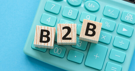 B2B, business to business marketing, business word on wooden cubes over blur background.