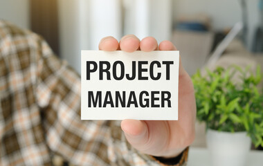 Businessman holding sheet of paper with text Project Manager. Teamwork, unity, partnership, new...