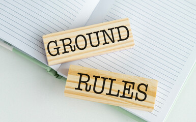 Ground rules text on wooden block on white background, business concept.
