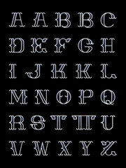 An outline old school capitals only alphabet with median spurs and a gradient fill. 
