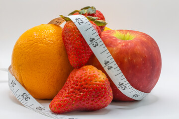 orange strawberry fruit apple measuring tape on white healthy nutrition diet isolated citrus sweet fresh vegetarian recommended lifestyle vegan vegetarian 