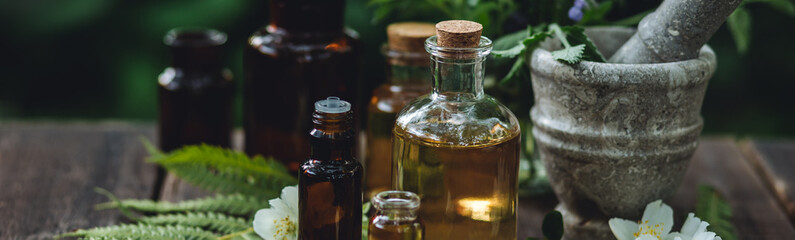 Herbal essential oil in old vintage apothecary glass bottles. Alternative medicine, skin care,...