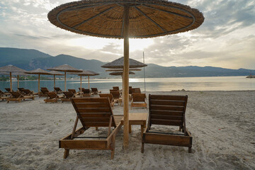 wooden sun beds and parasols on Alikanas beach