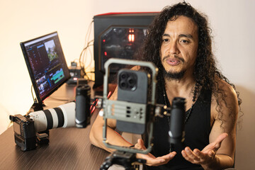 Mobile Studio for Content Creation. A long-haired content creator immersed in his studio, recording...