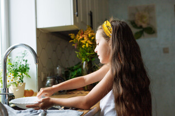 House, washing dishes or kid or dirty plates in kitchen sink at home for healthy hygiene. Learning independence, child development or boy cleaning to disinfect or prevent bacteria germs