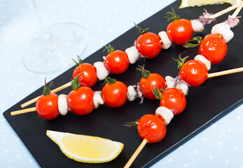 Skewers with mini calamari and cherry tomatoes grilled with olive oil and balsamic sauce