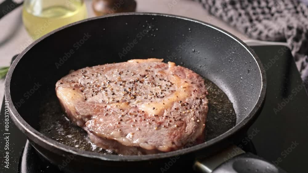 Poster delicious juicy beef steak meat cooking on a pan in melted butter. process of making perfect steak a