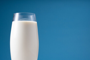 Glass of Milk on a Blue Bakground