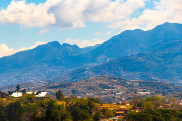 Fototapeta premium Runway airport city mountains panorama view from airplane Costa Rica.