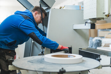 young craftsman holding a tape at the carpentry workshop. High quality photo