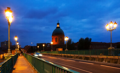 Night view of Hospital de la Grave dome and Saint-Pierre Bridge in Toulouse, France
