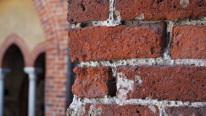 Ancient red brick facade texture - the arched wall fragment in a closeup view built in the medieval...
